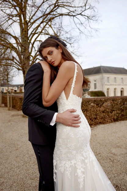 XAYWEAR wedding dress with lace details and deep back worn outdoors with groom in black suit
