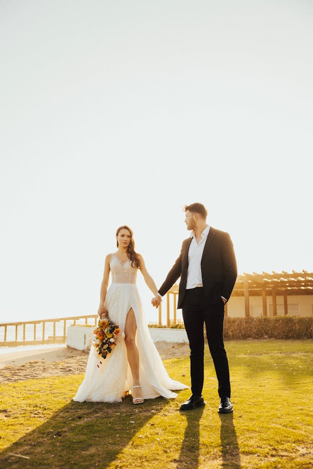 XAYWEAR elegant wedding gown with thigh slit worn by bride holding bouquet outdoors