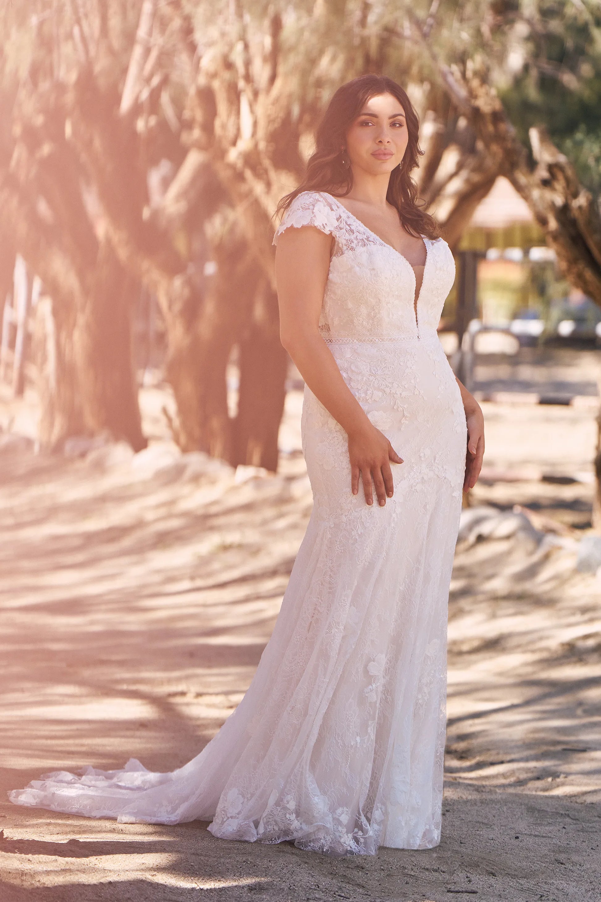 XAYWEAR elegant wedding gown with lace details and cap sleeves worn outdoors