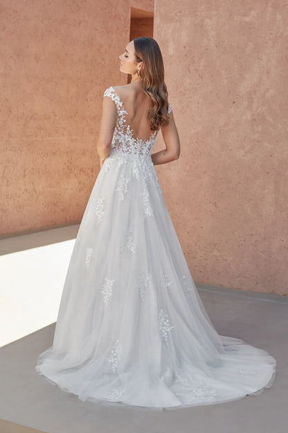 Elegant XAYWEAR wedding white gown with lace details and a flowing train, shown from the back