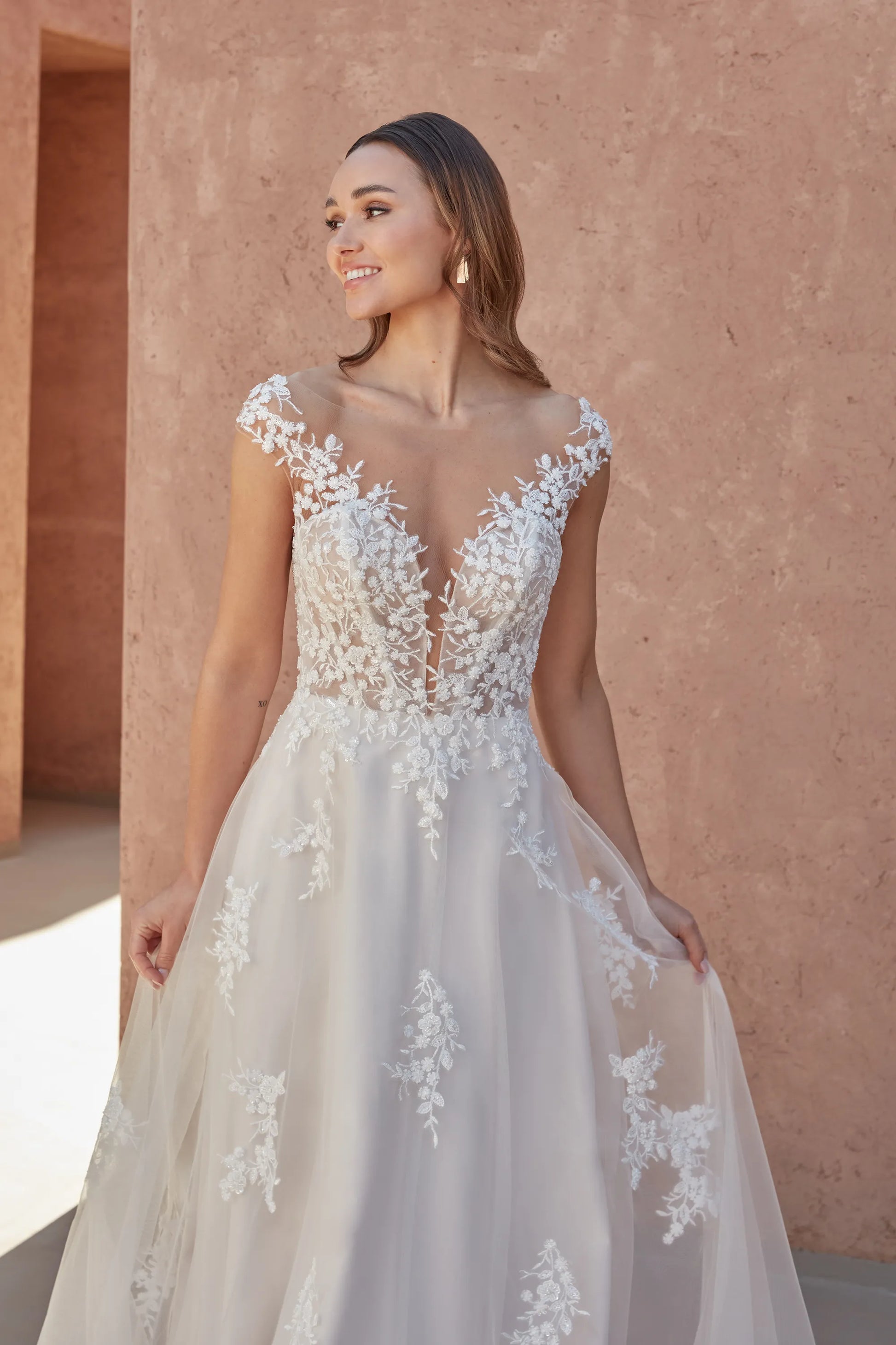 XAYWEAR wedding white gown with floral lace appliques and sheer neckline on model