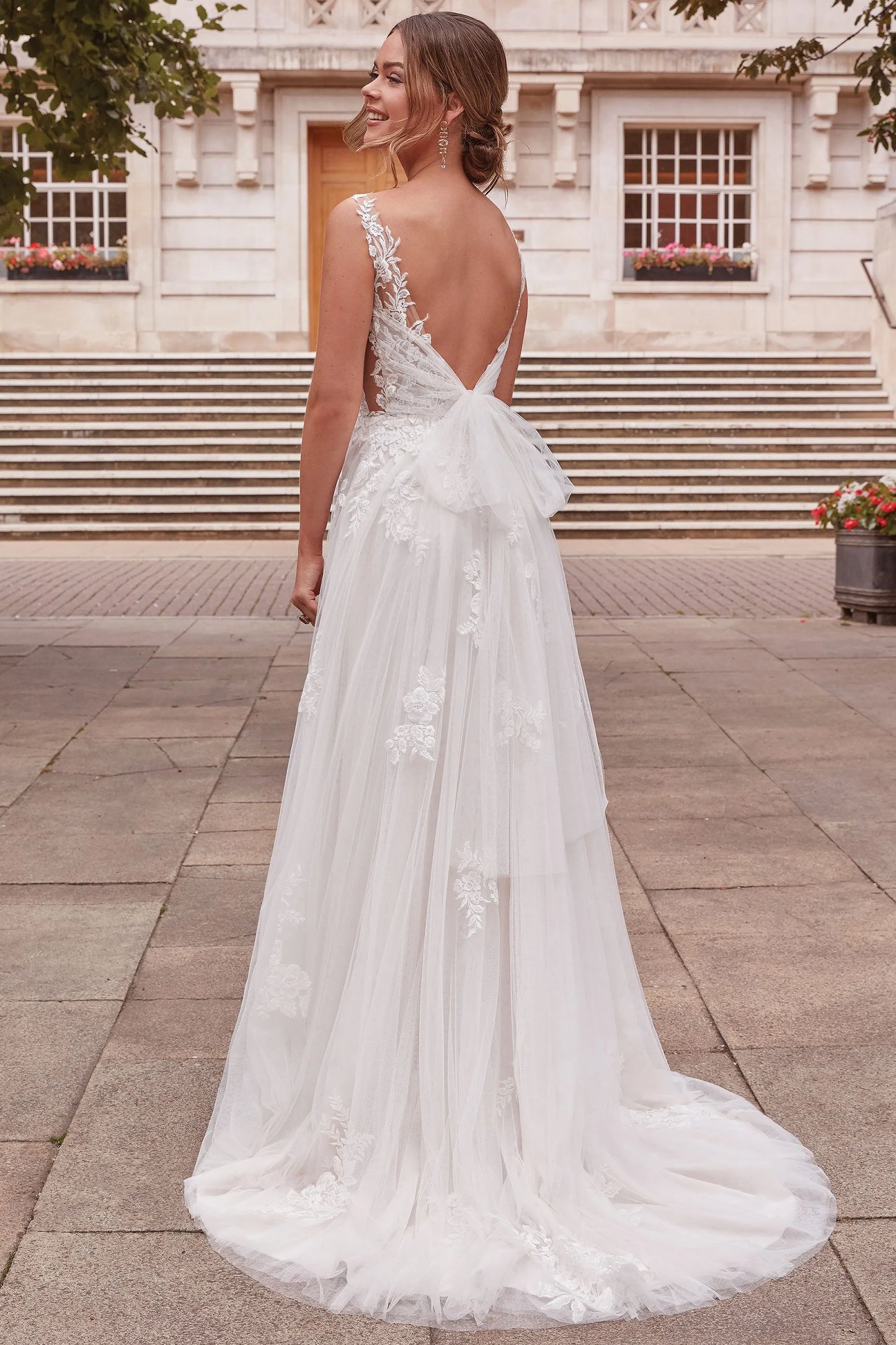 XAYWEAR elegant wedding dress with lace detailing and low back design featuring a large bow