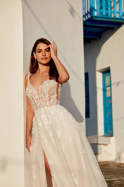 XAYWEAR white wedding dress with lace bodice and flowing skirt worn by model outdoors