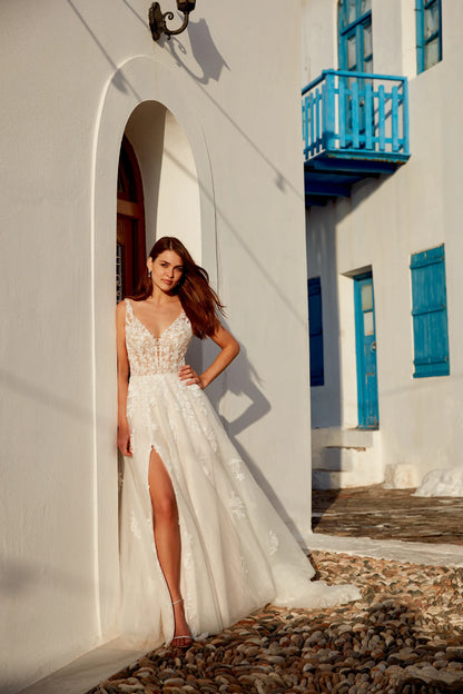 Elegant white wedding dress gown by XAYWEAR with lace bodice and thigh-high slit worn outdoors