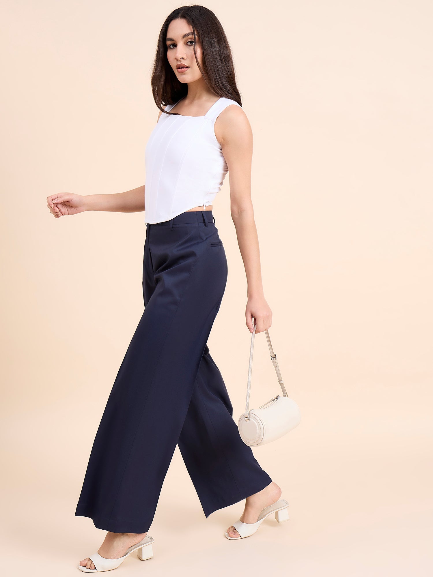 XAYWEAR stylish white women outfit featuring a sleeveless white top with navy wide-leg pants