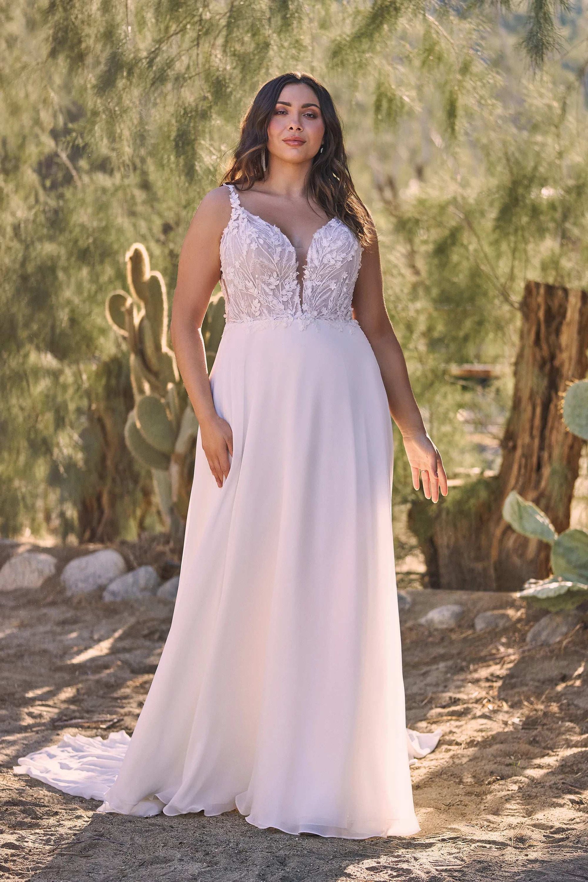 XAYWEAR wide strap lace wedding gown with elegant bodice and flowing skirt in a natural setting