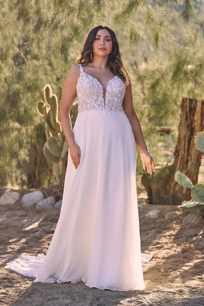 XAYWEAR wide strap lace wedding gown with elegant bodice and flowing skirt in a natural setting