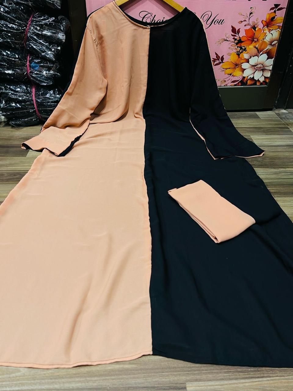 Elegant women black abaya with contrasting peach and black colors, perfect for modest fashion
