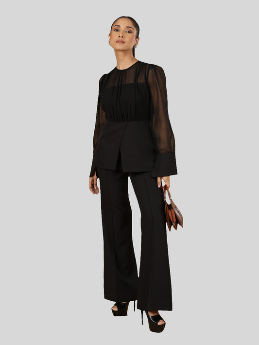 XAYWEAR women black blouse with sheer long sleeves paired with black pants and heels