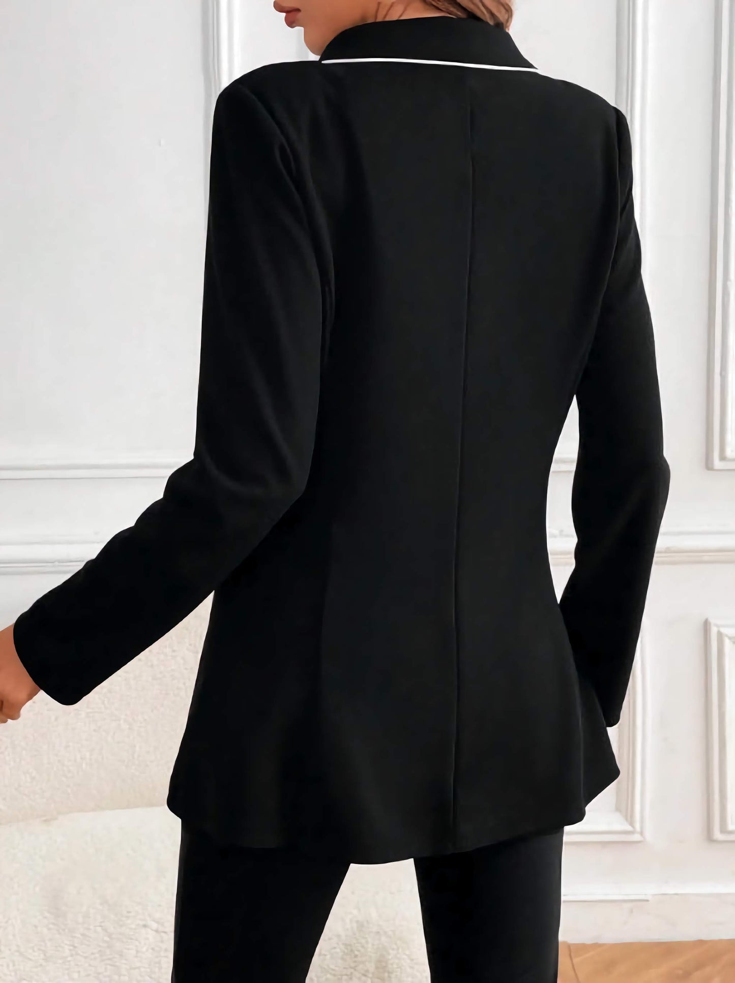 Back view of women black suit set by XAYWEAR featuring a fitted blazer with white collar detail