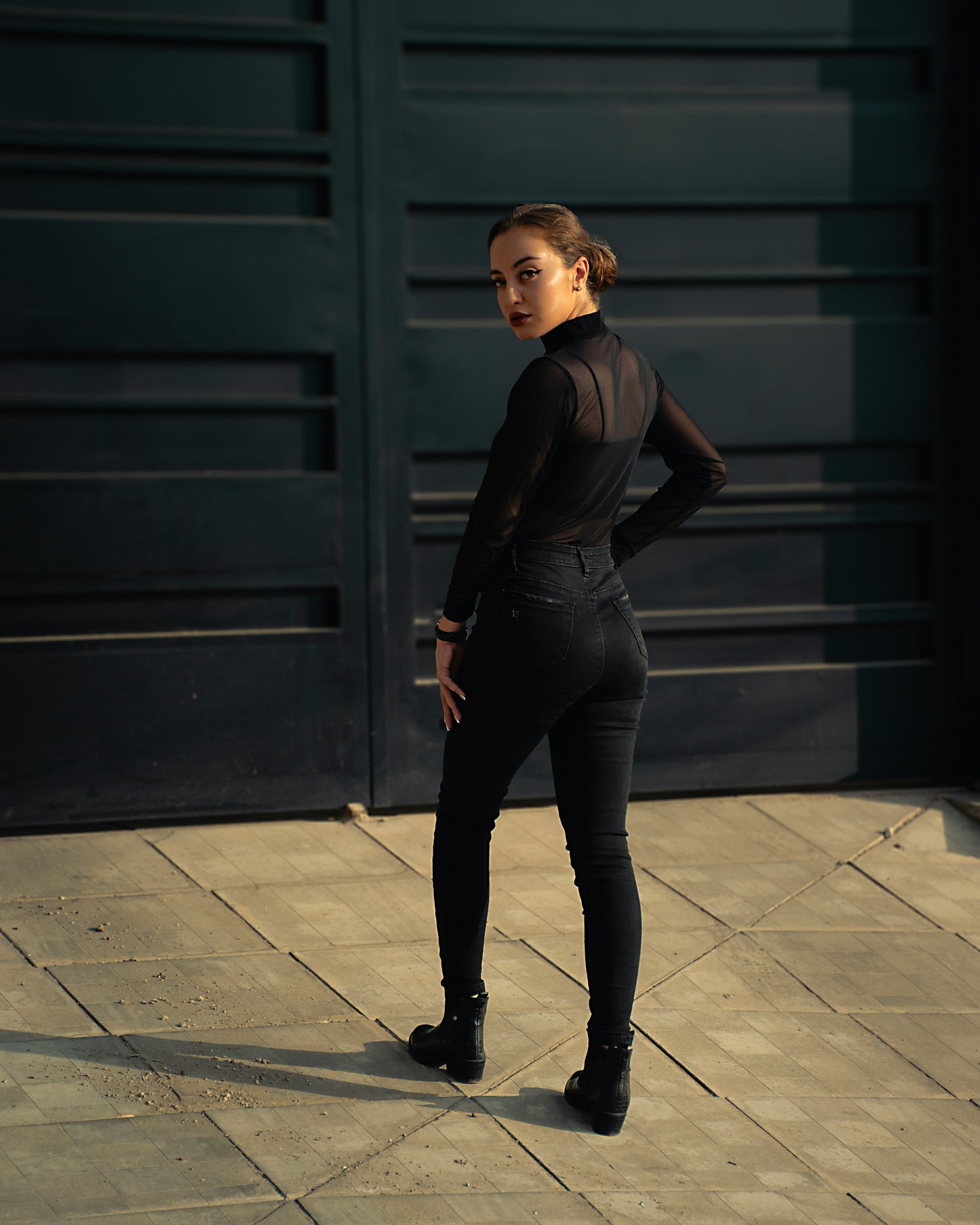 XAYWEAR women black top with sheer long sleeves paired with black skinny jeans and boots