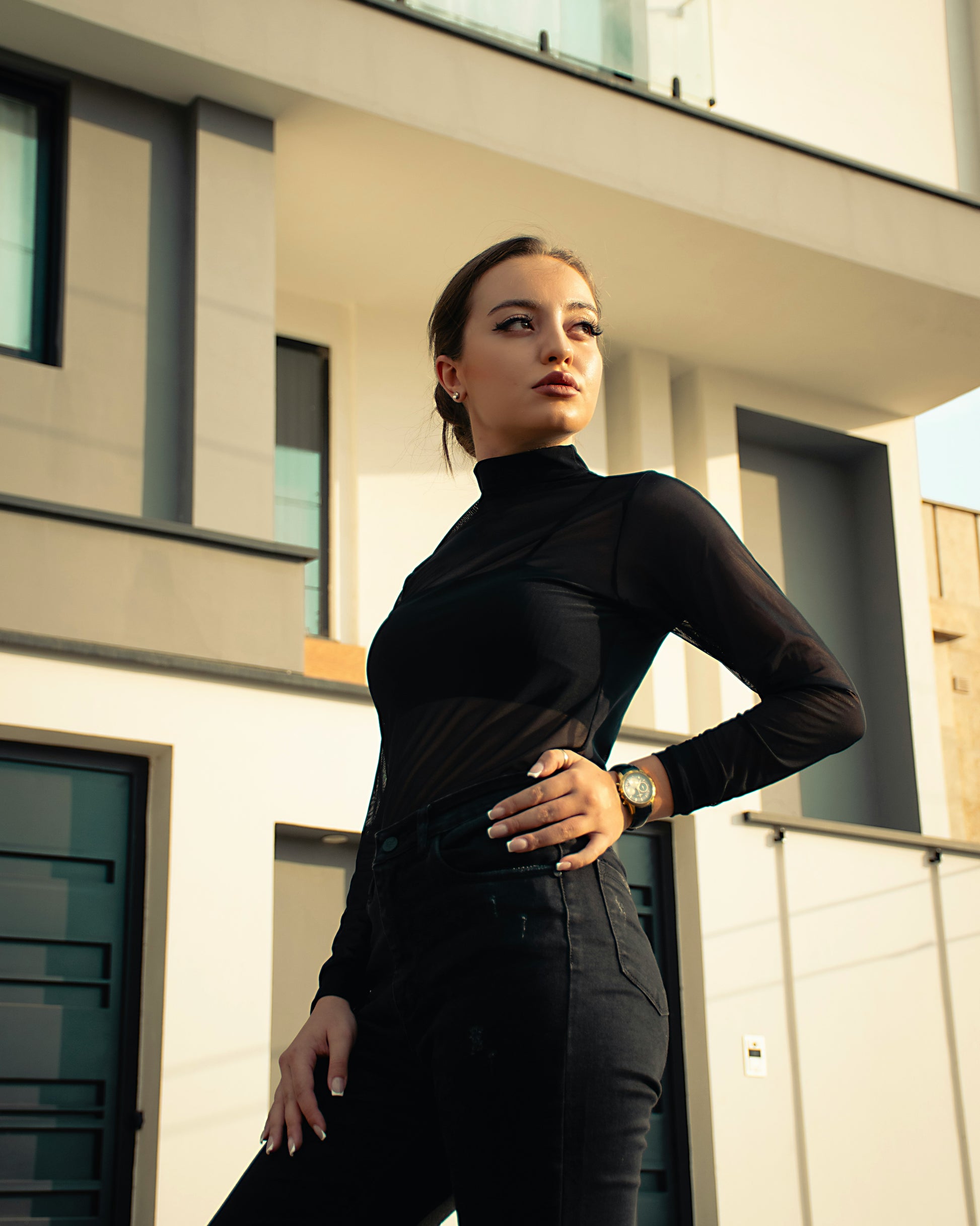 XAYWEAR women black top with long sleeves and high neck worn outdoors in modern urban setting