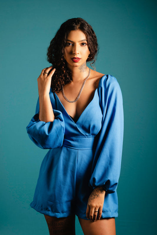 XAYWEAR women blue jumpsuit with long puff sleeves and deep V neckline styled on model