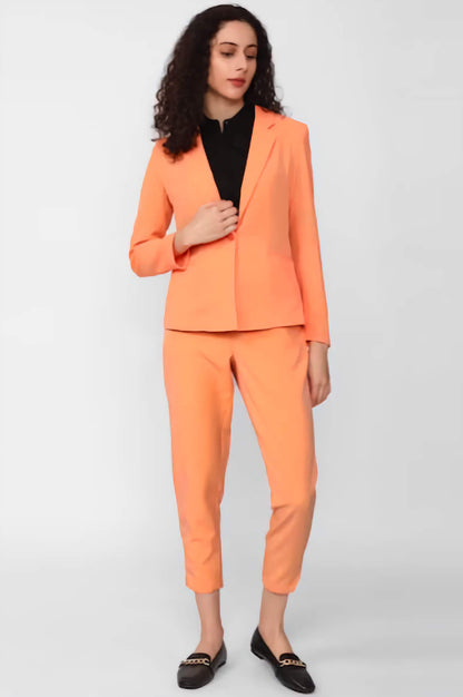XAYWEAR orange suit with blazer and cropped pants modeled as a women business outfit