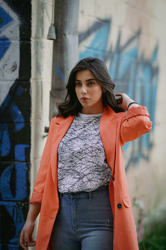 XAYWEAR orange blazer styled as a women coat with casual printed shirt and jeans