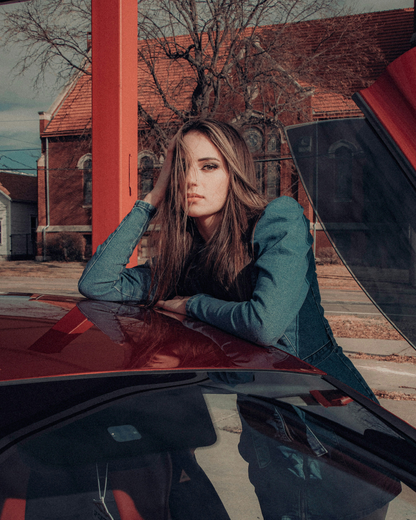 XAYWEAR women denim midi dress worn by model leaning on red car at outdoor urban location