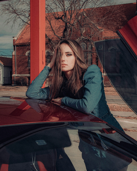 XAYWEAR women denim midi dress worn by model leaning on red car at outdoor urban location