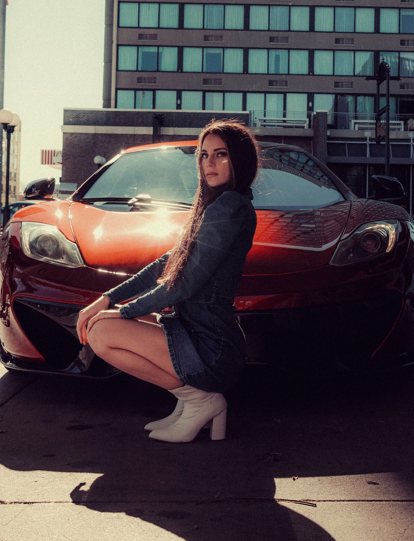 XAYWEAR women denim midi dress worn by woman crouching in front of red sports car outdoors