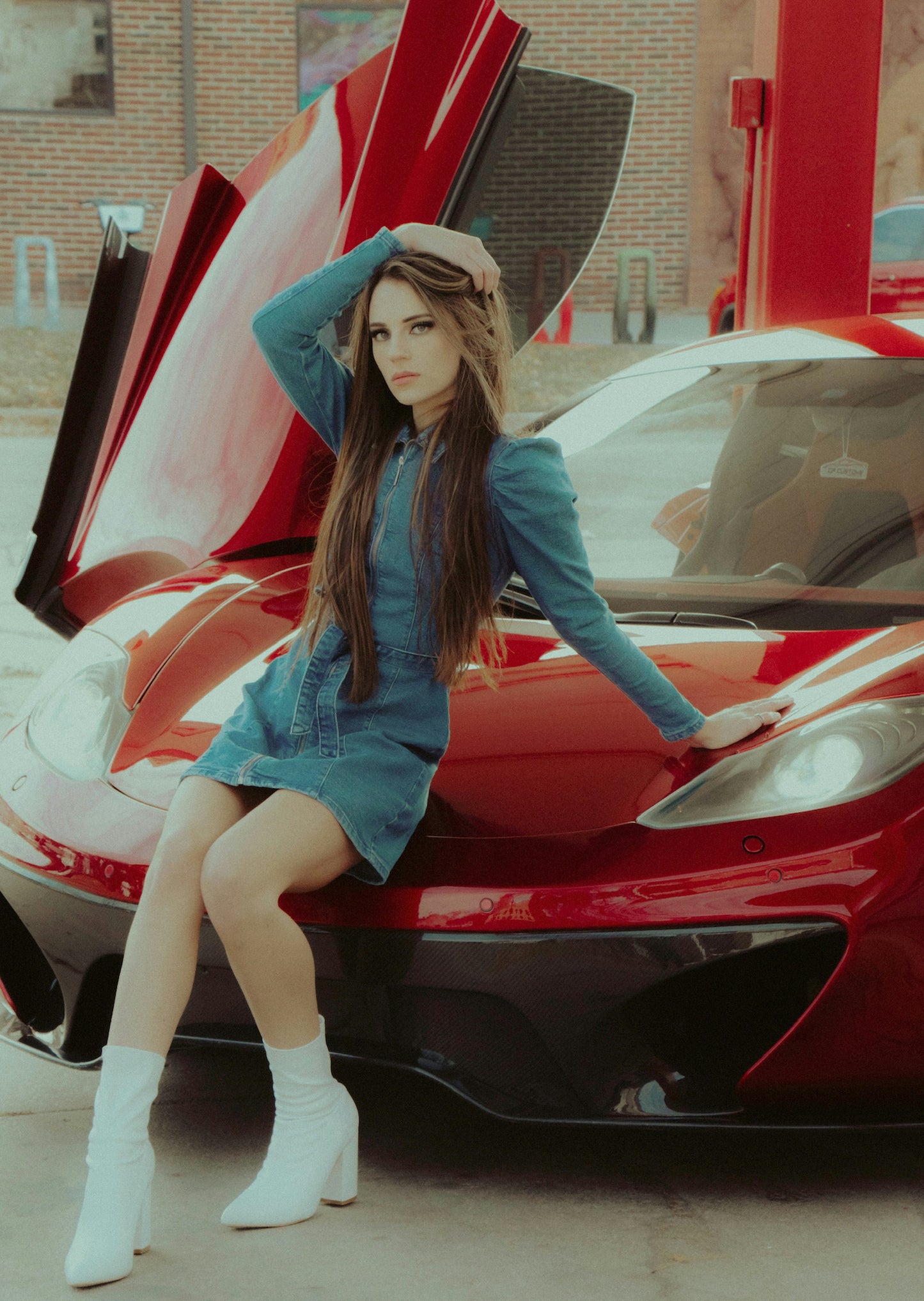 XAYWEAR women denim midi dress modeled sitting on red sports car with white ankle boots