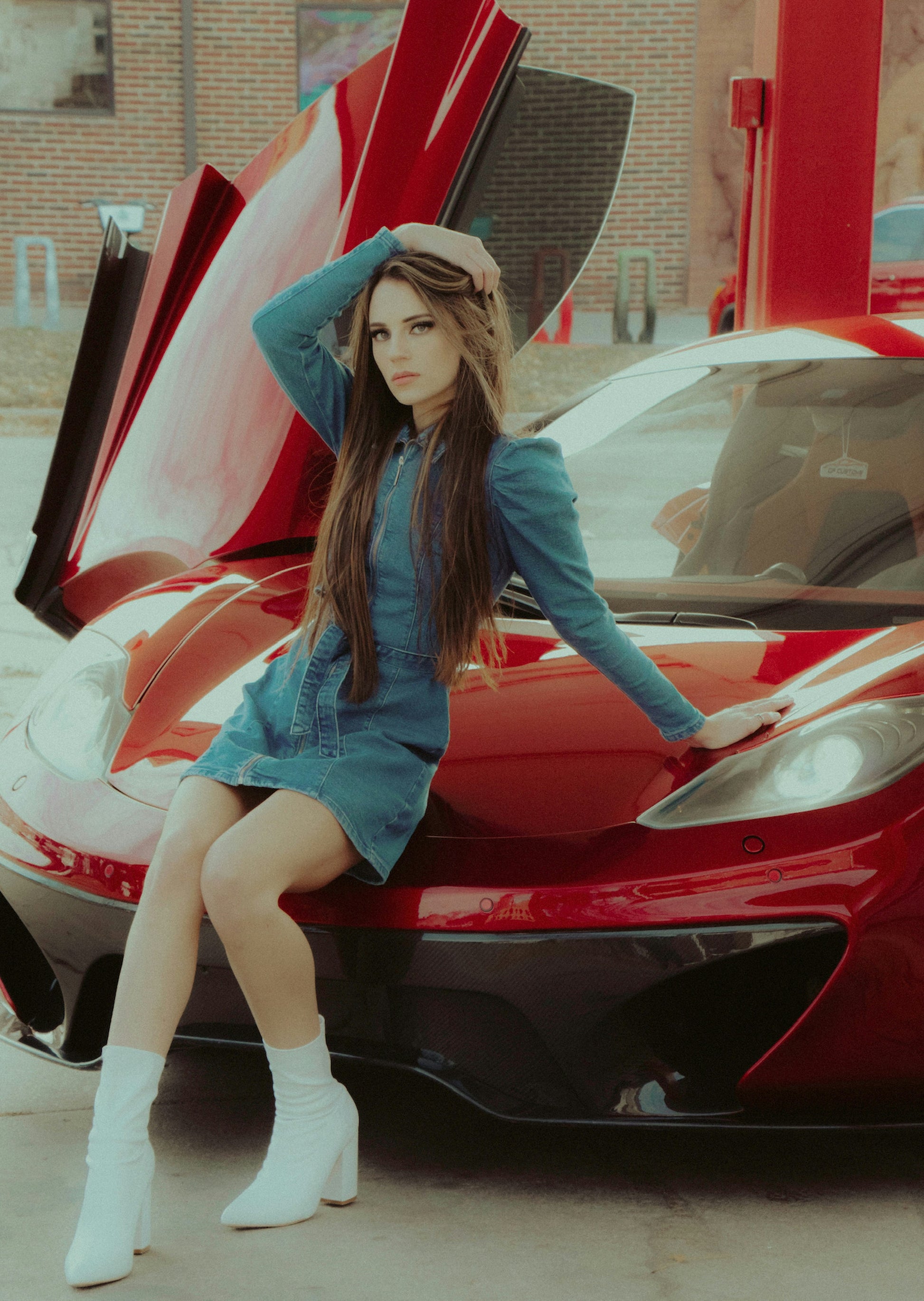 XAYWEAR women denim midi dress modeled sitting on red sports car with white ankle boots