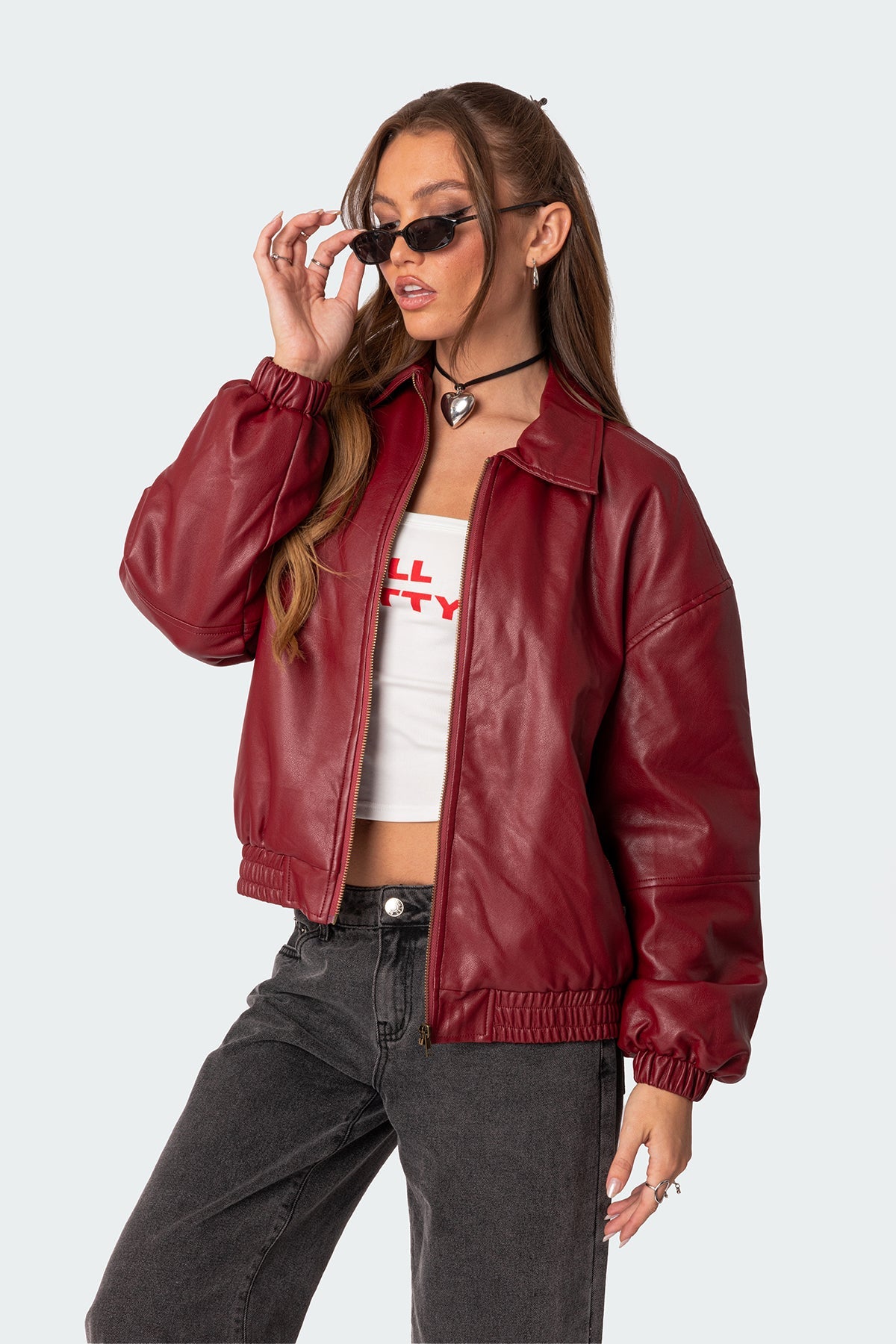 XAYWEAR red women leather jacket with front zipper and elastic cuffs styled with casual black jeans