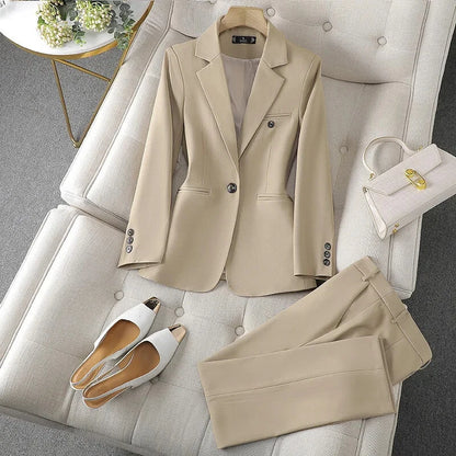 Beige XAYWEAR suit for women with tailored blazer and matching pants laid on a sofa with white shoes and handbag