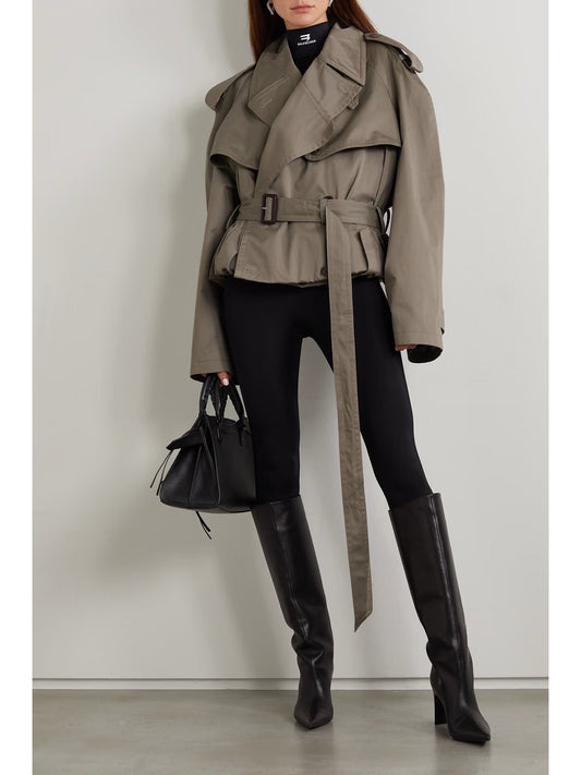XAYWEAR women trench coat in taupe with belted waist and wide lapels styled with black boots and handbag