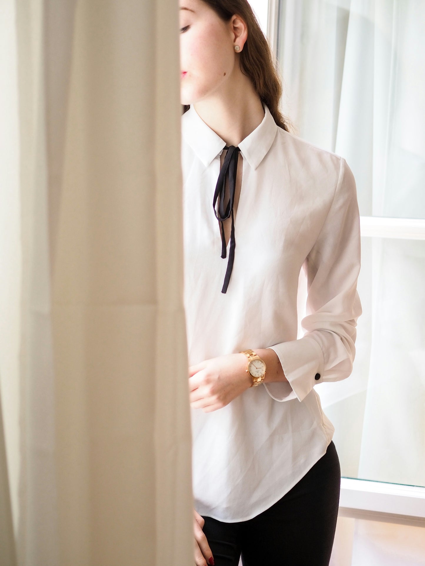 XAYWEAR women white shirt with black tie detail worn by a model standing by a window