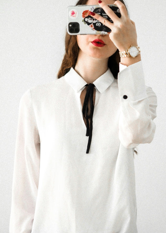 XAYWEAR women white shirt with black ribbon tie and long sleeves worn by a woman taking a selfie