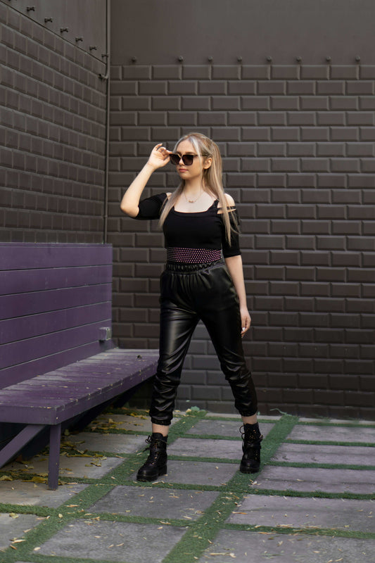 Woman wearing XAYWEAR Faux Leather Joggers for Women Trendy Comfort standing outdoors with sunglasses